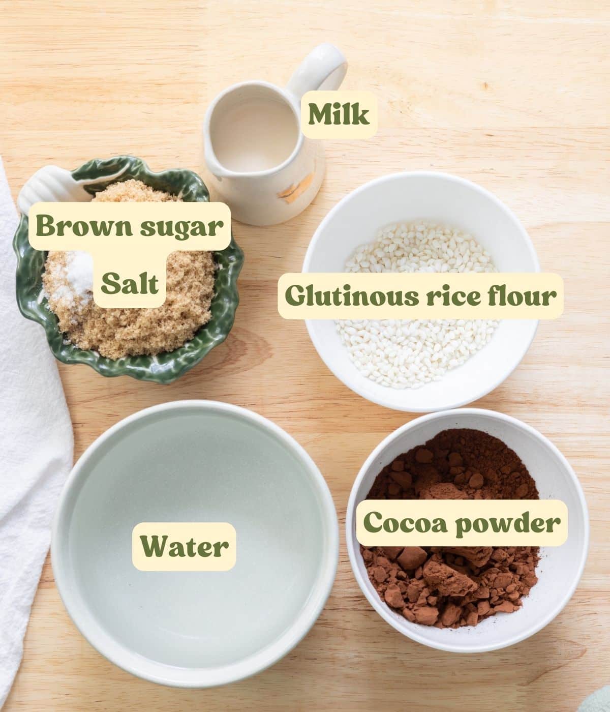 Champorado ingredients laid out on a wooden table, with labels for each ingredient.
