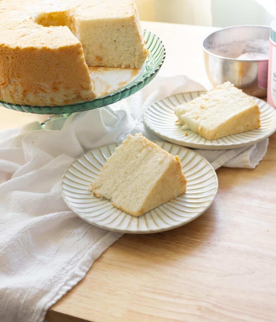 Angel food cake slice on a fluted plate.