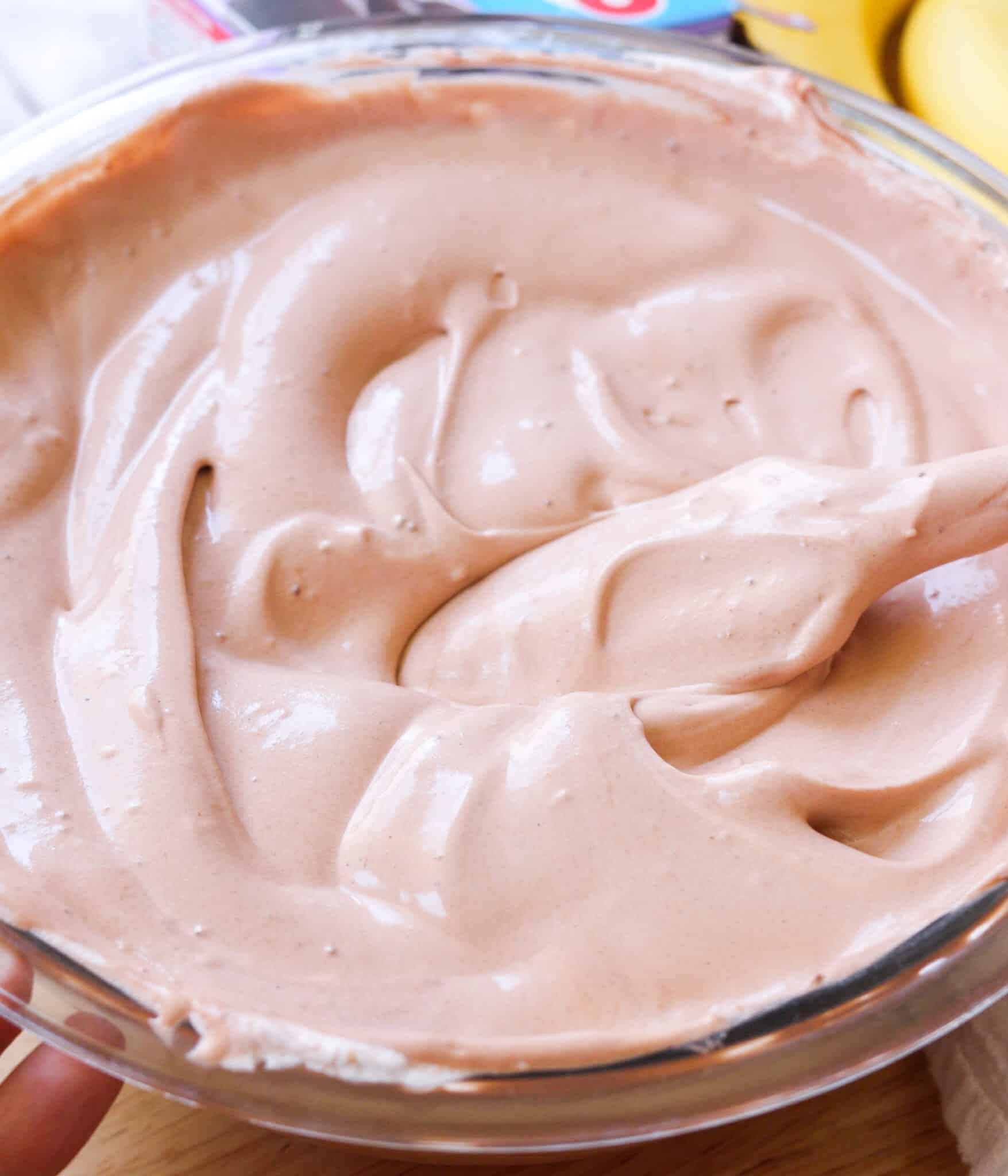 Light and creamy chocolate banana pudding mixture in a glass bowl.