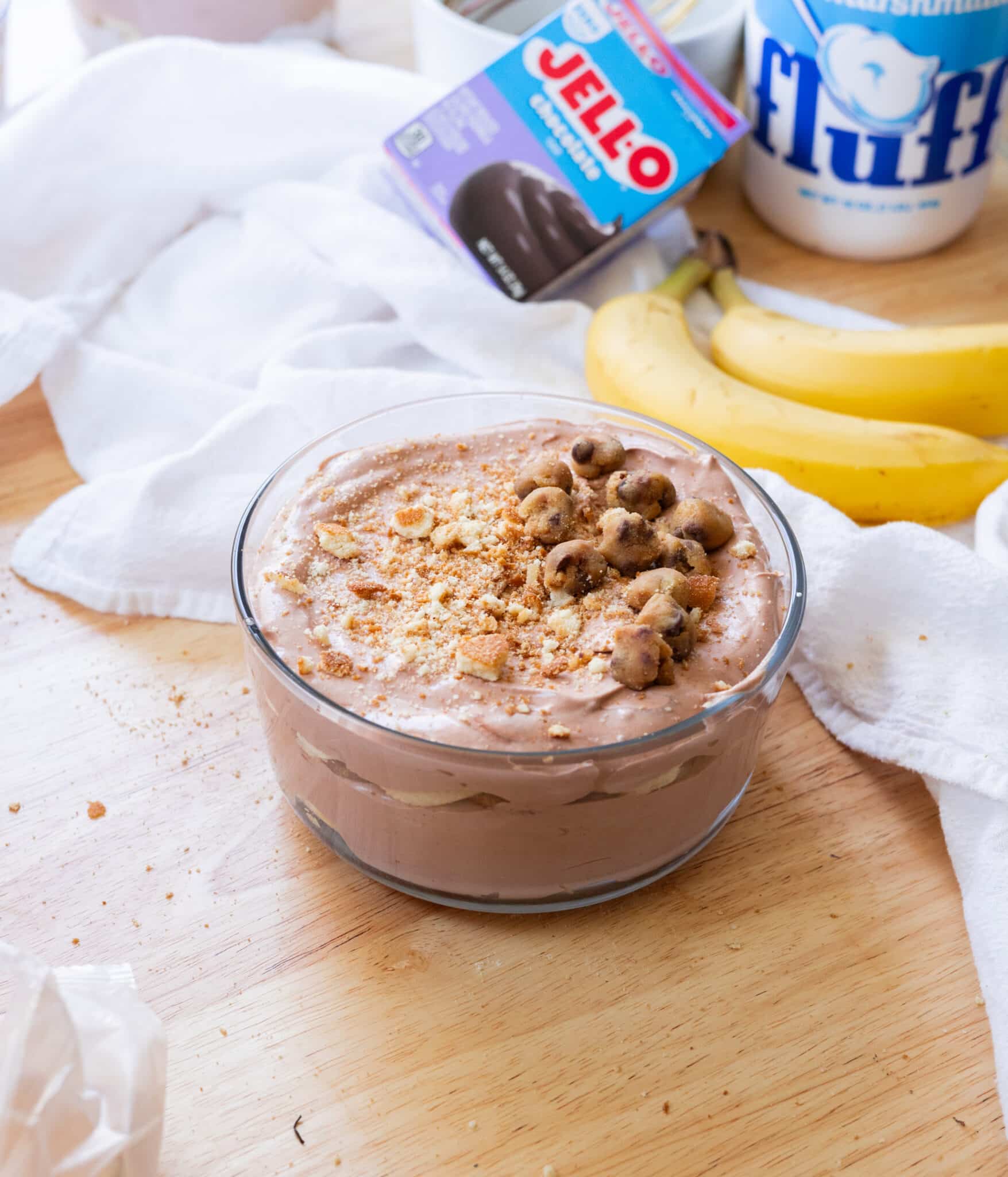 Chocolate banana pudding in a glass container.