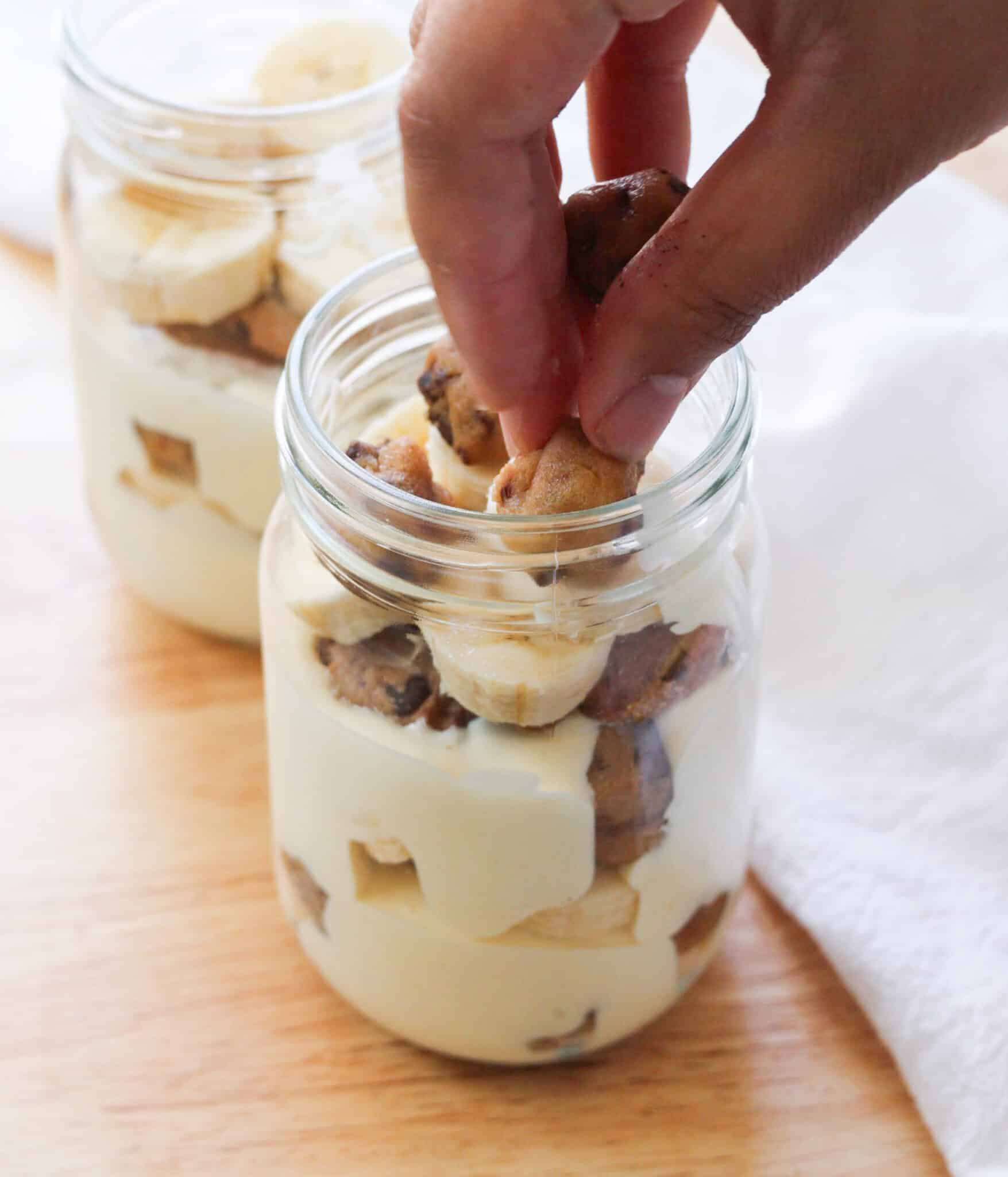 Layering cookie dough on top of bananas for banana pudding.