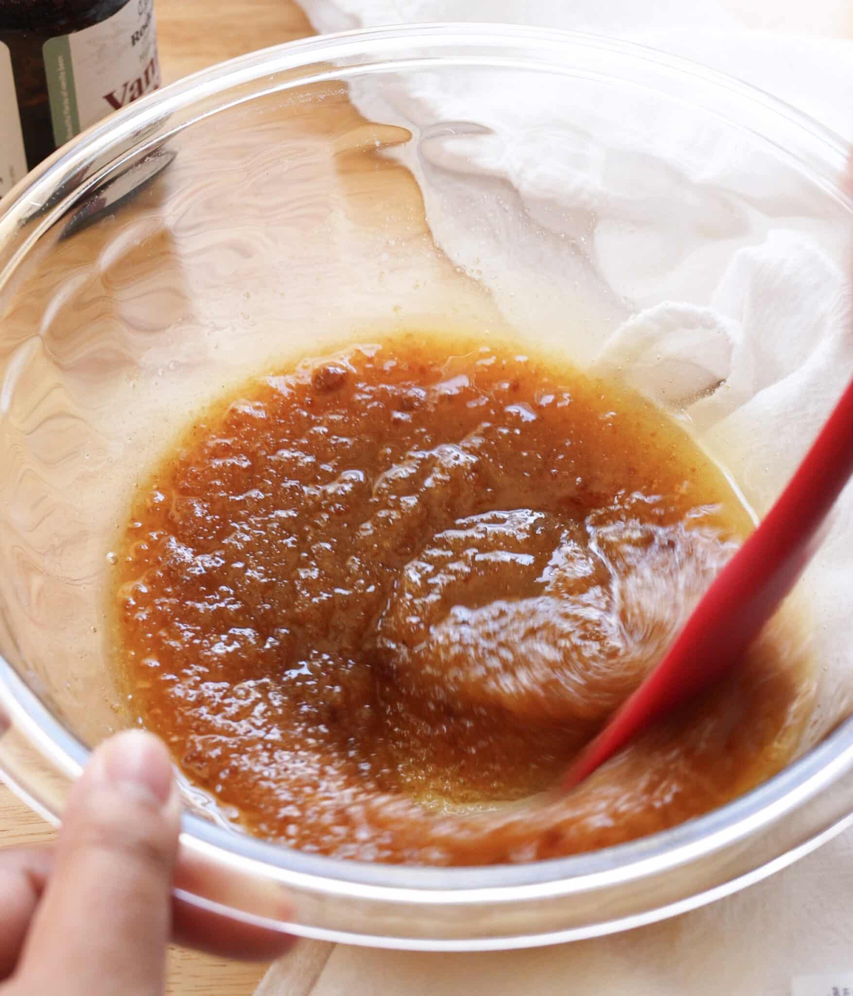 Melted butter and sugars mixed together in a glass bowl.