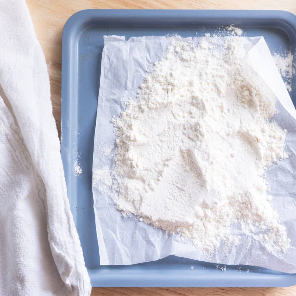 Heat treated flour on a lined baking sheet.