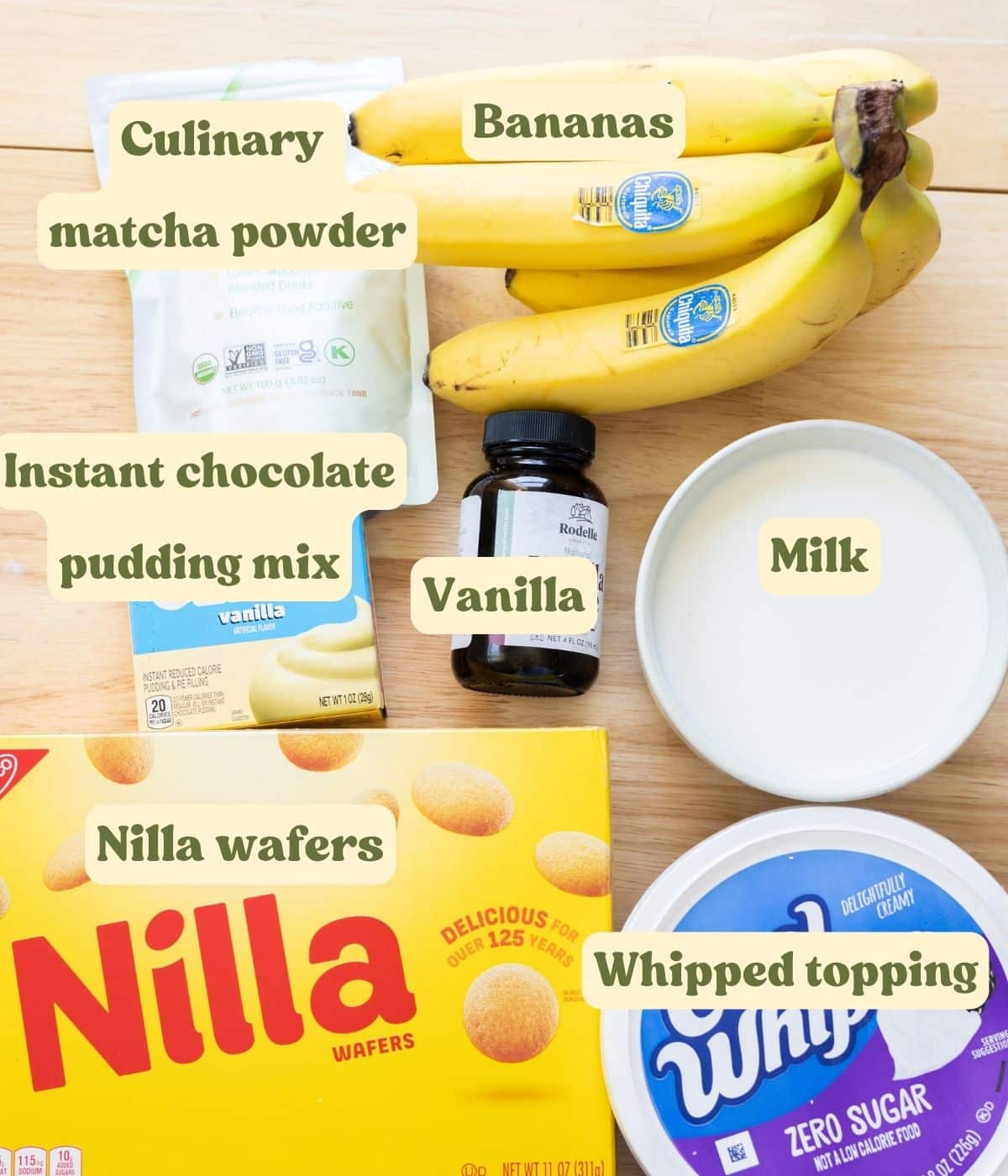 Homemade matcha banana pudding labeled ingredients on a wooden table.