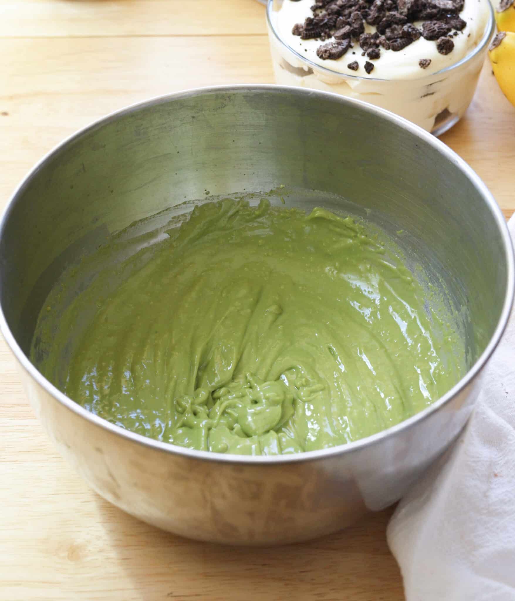 Mixed matcha vanilla pudding in a stainless steel bowl.