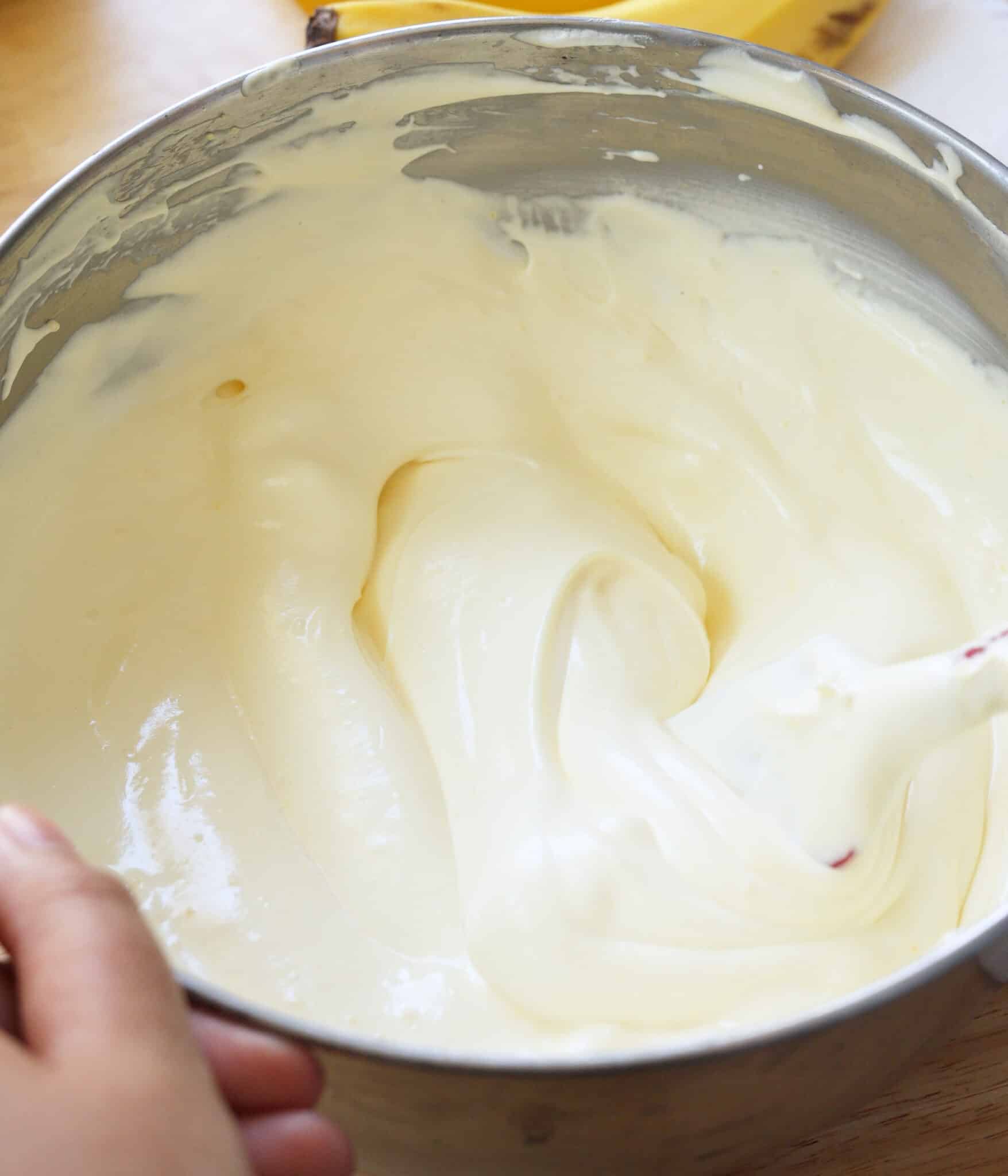 Light and creamy vanilla pudding mixture in a stainless steel bowl.