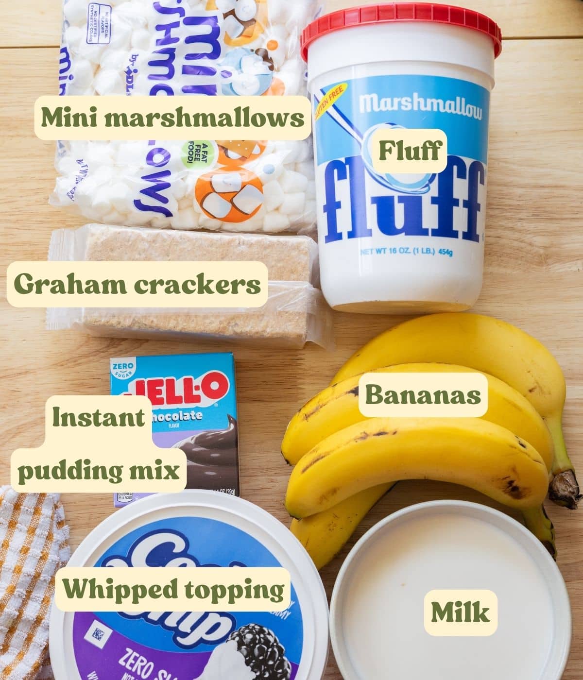 S'mores banana pudding labeled ingredients on a wooden table.