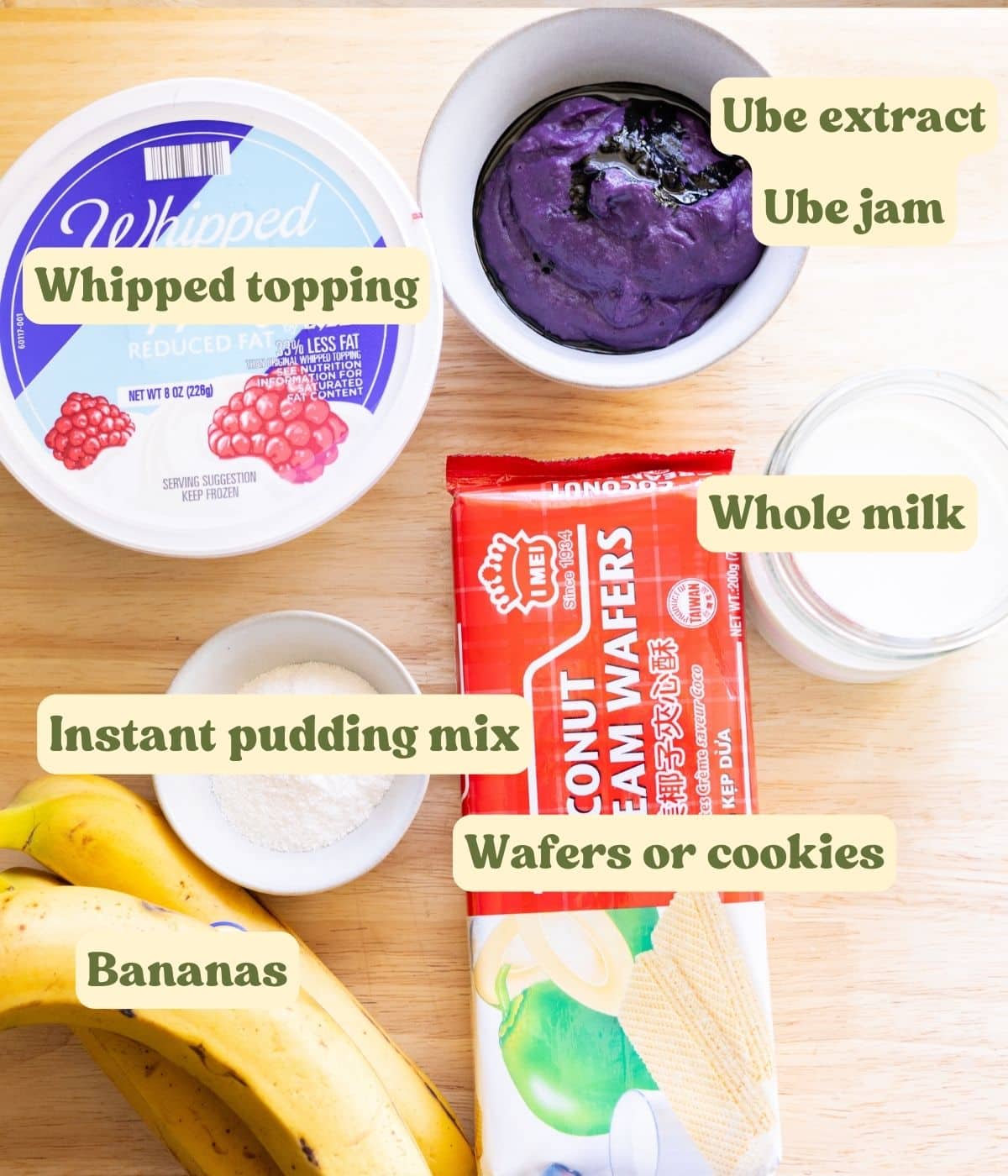 Homemade ube banana pudding labeled ingredients on a wooden table.