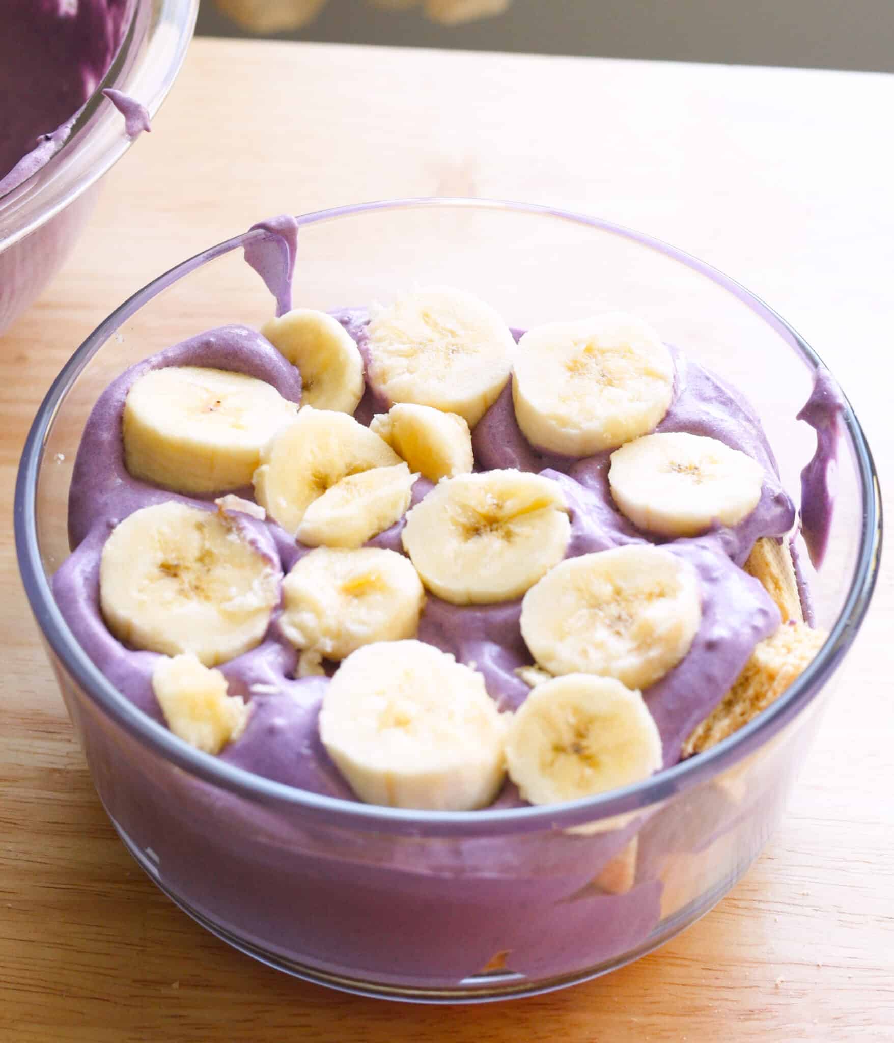 Layering sliced bananas on top of wafers for banana pudding.