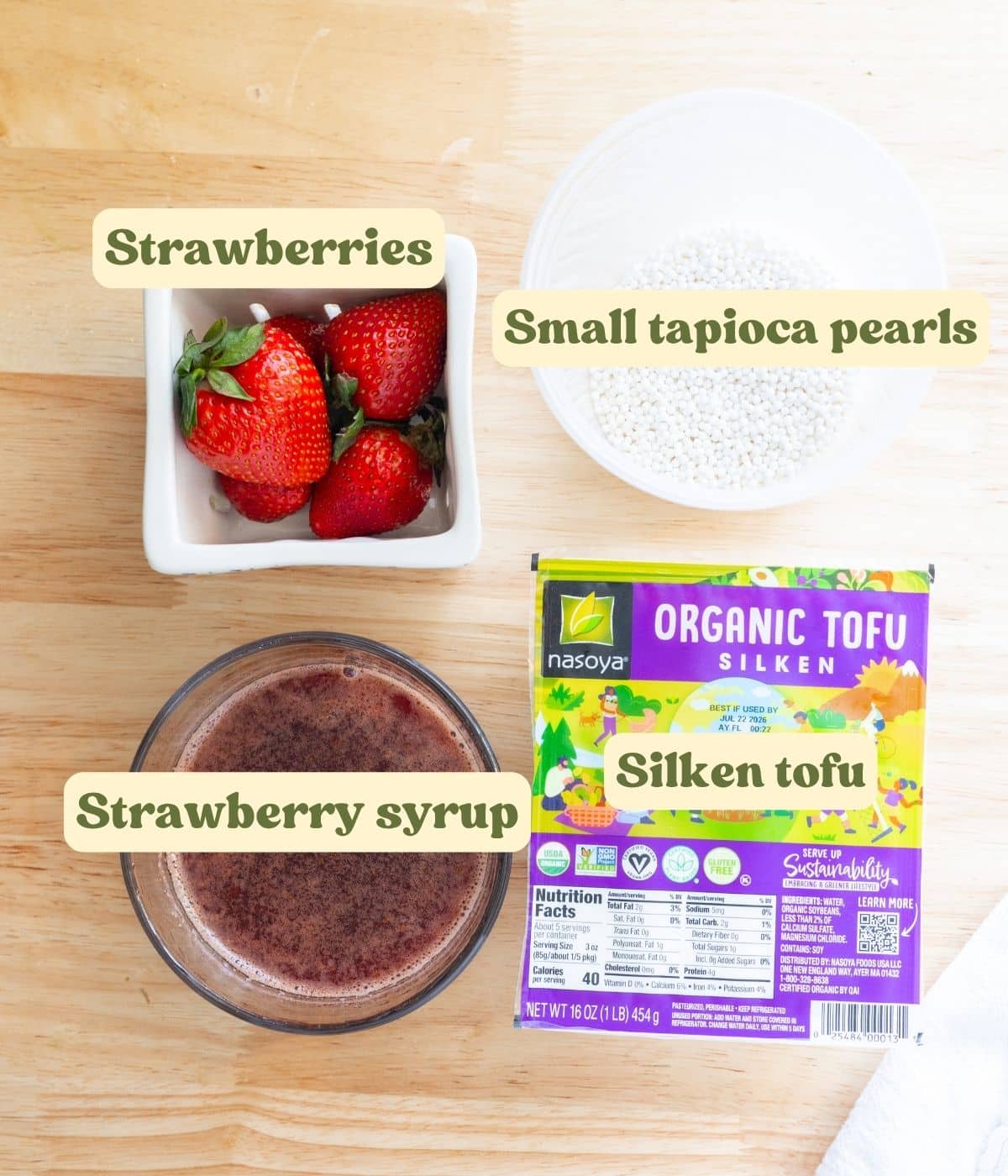Filipino strawberry taho labeled ingredients on a wooden table.