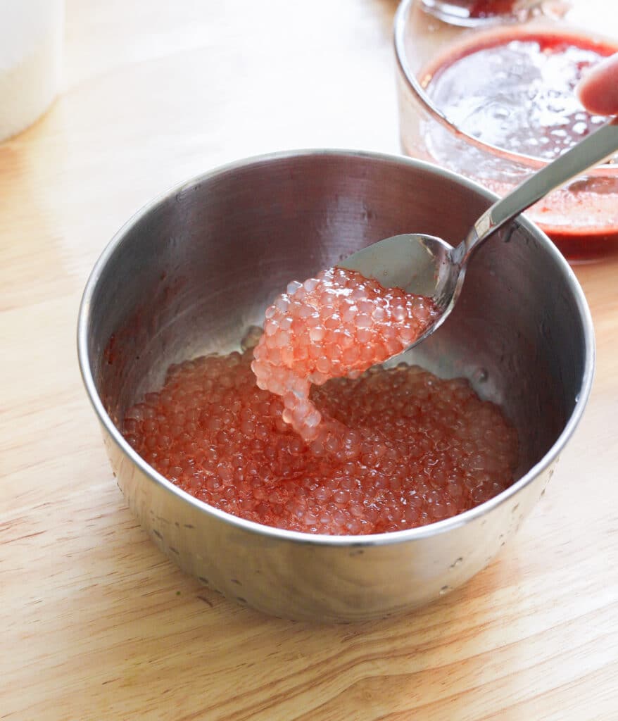 Cooked small tapioca pearls soaked in strawberry arnibal.