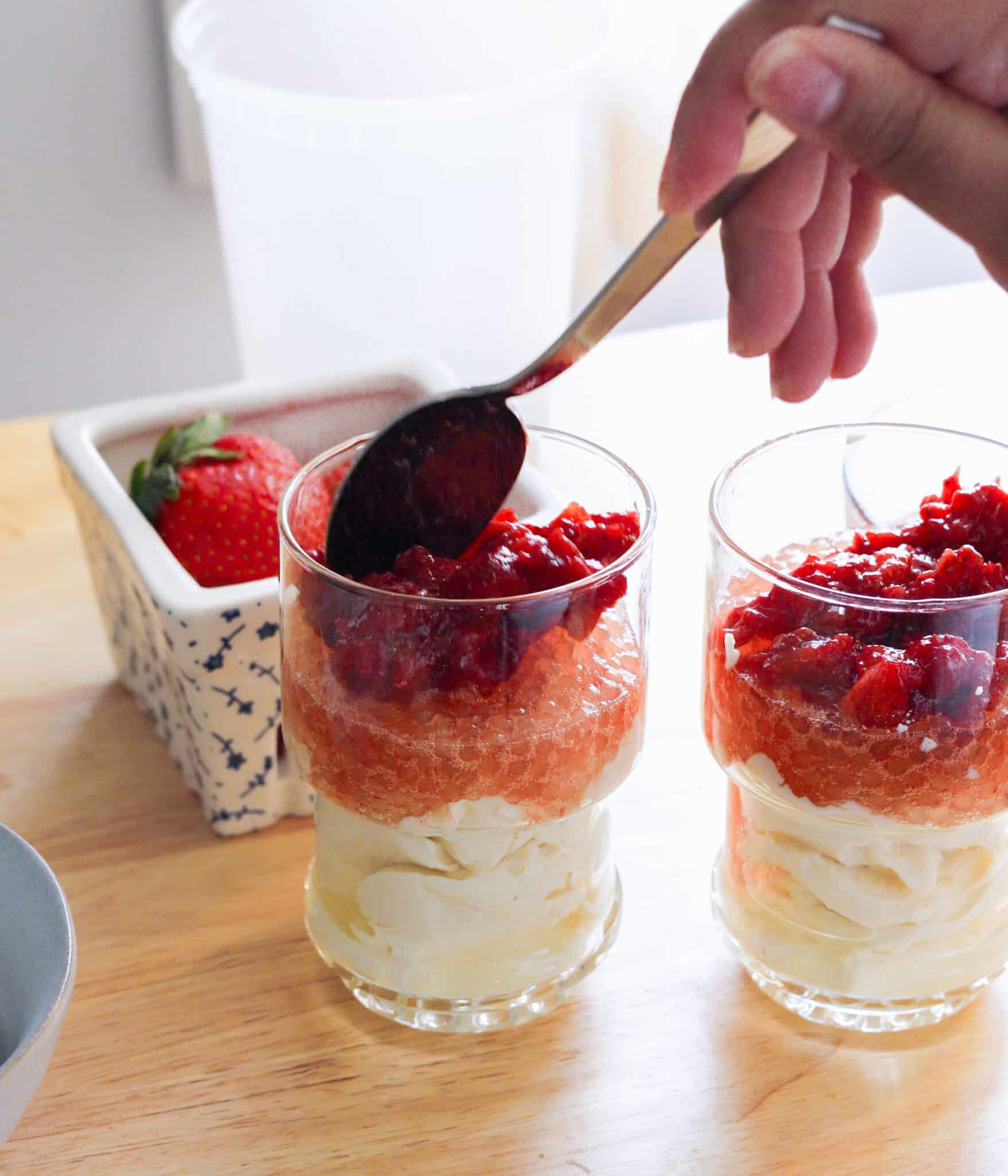 Layering strawberries into strawberry taho.