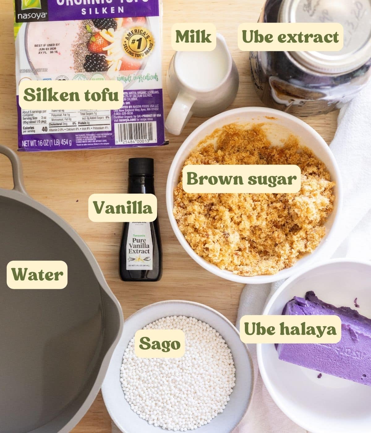 Filipino ube taho labeled ingredients on a wooden table.