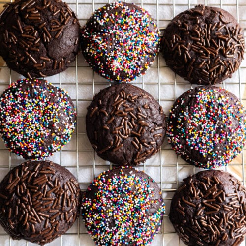 Chocolate sprinkle cookies on a wire rack.