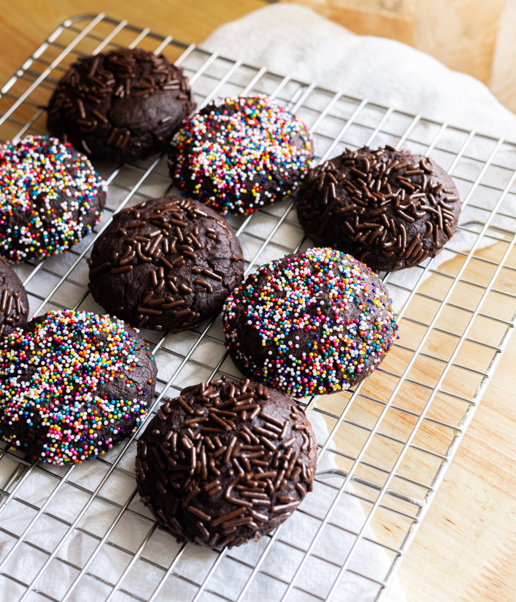 Chocolate sprinkle cookies on a wire rack.
