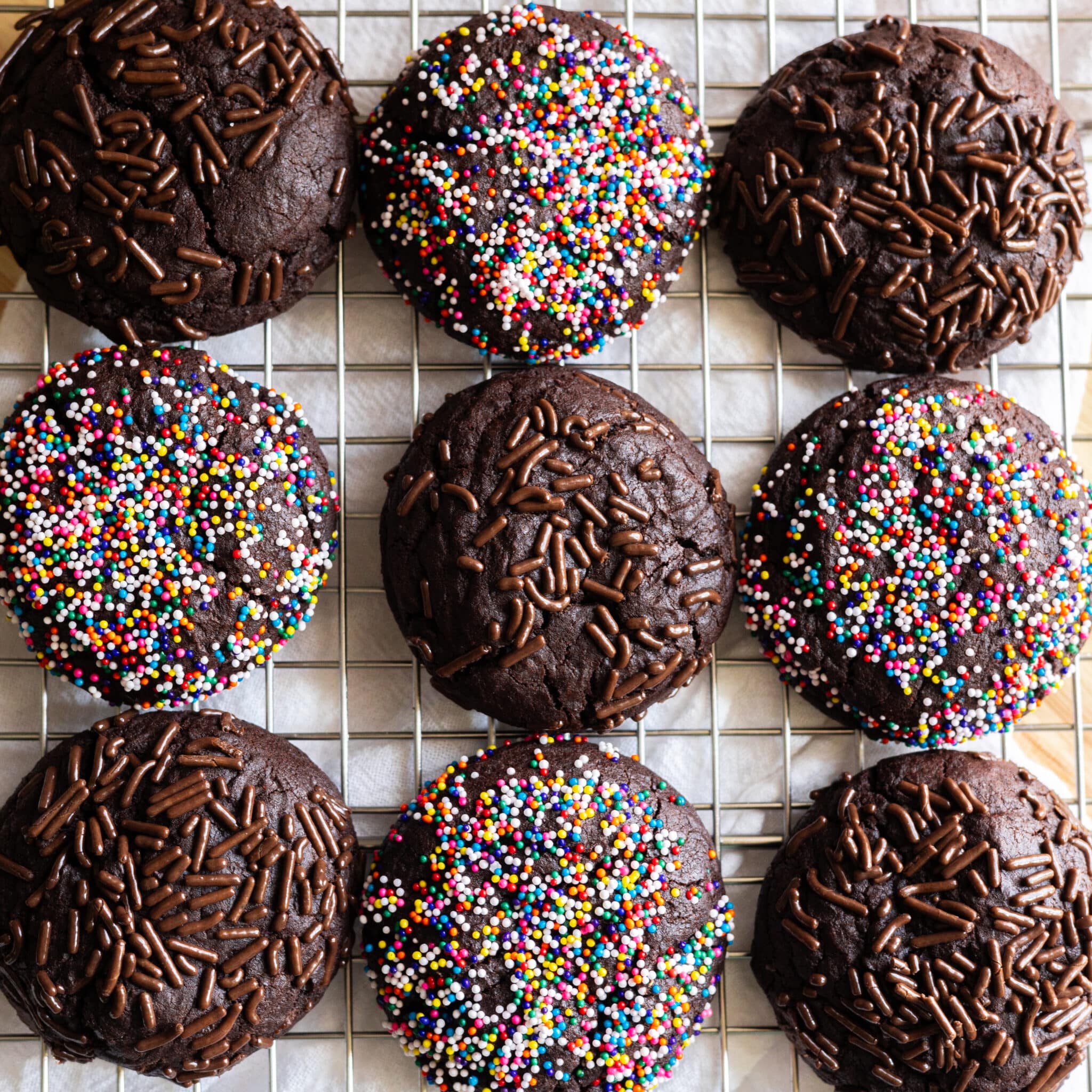 Chocolate sprinkle cookies on a wire rack.