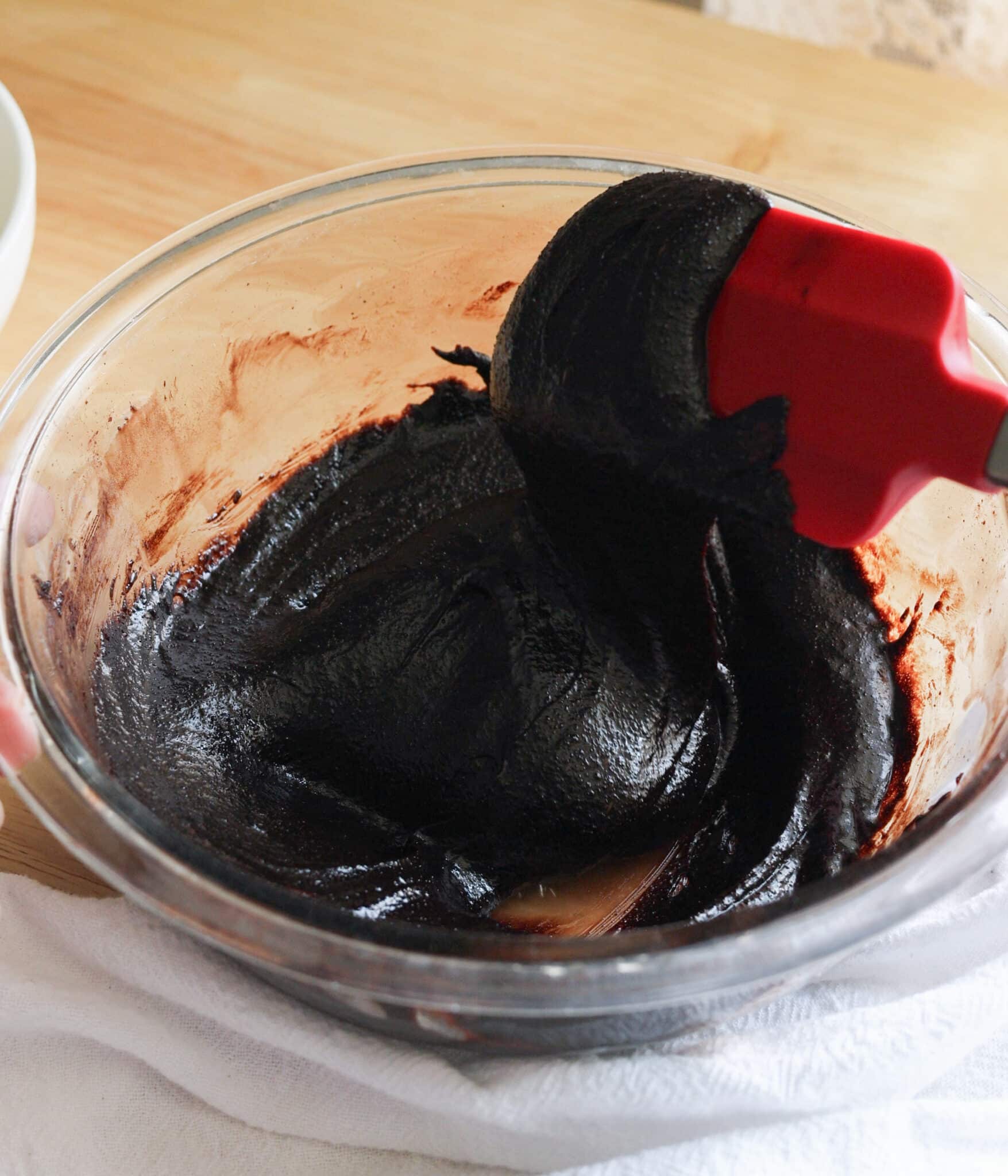 Chocolate cookie wet ingredients mixed in a glass bowl.