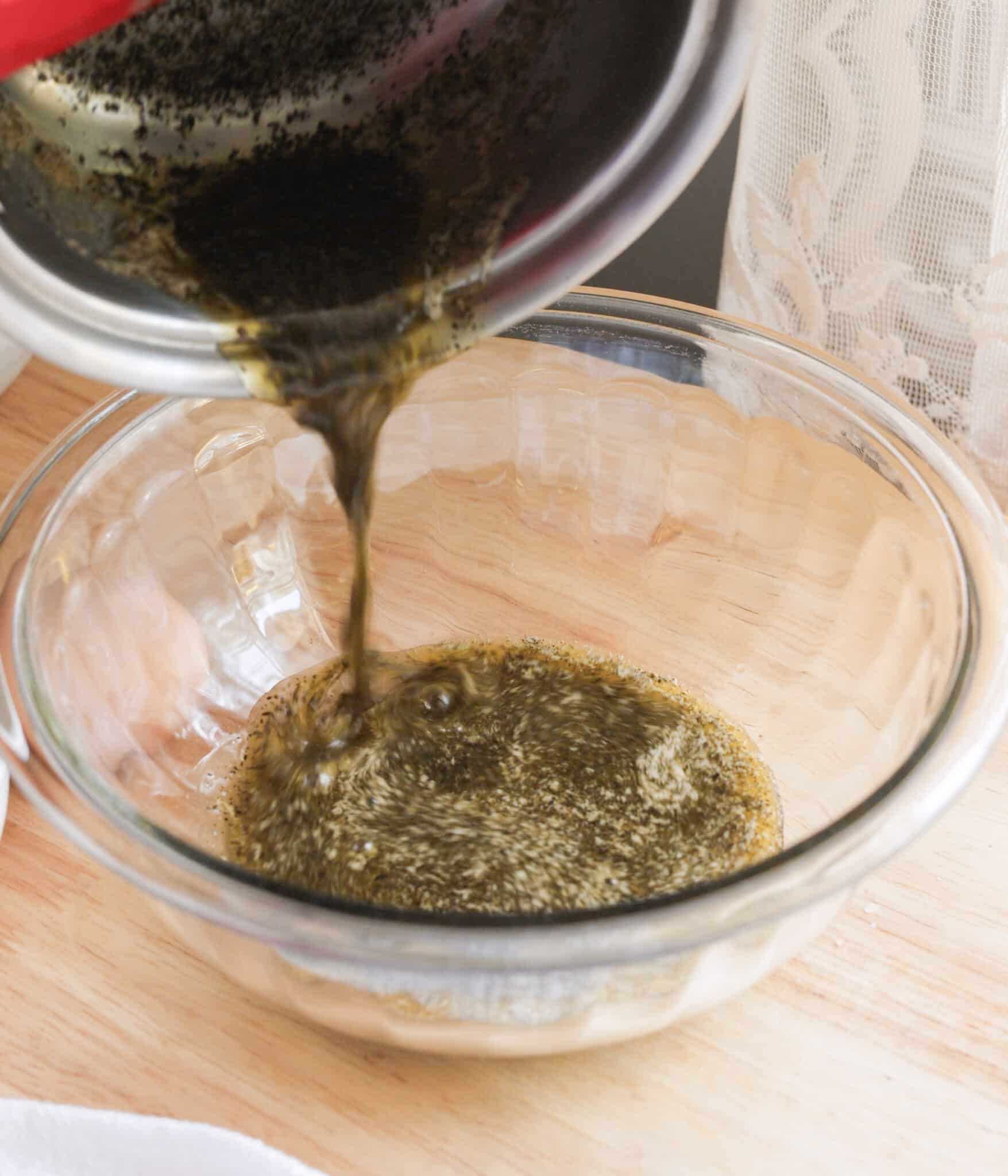 Pouring melted Jasmine-infused butter into a mixing bowl.