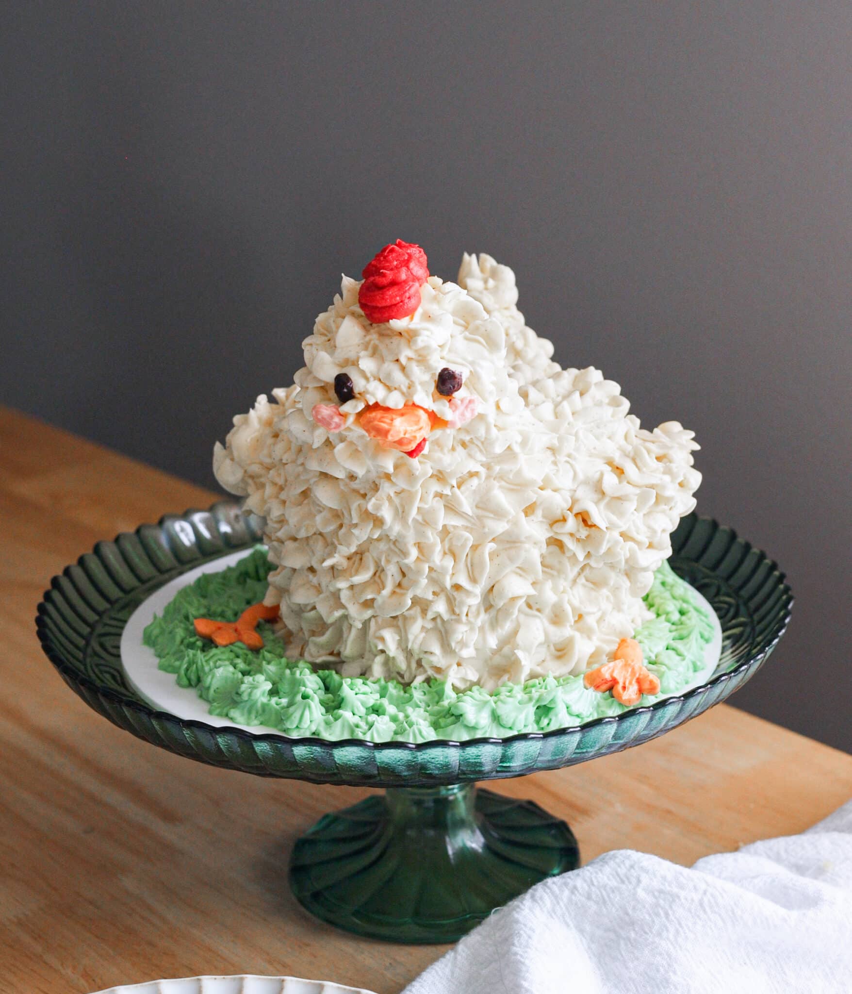 Menacing chicken cake on a green cake stand.