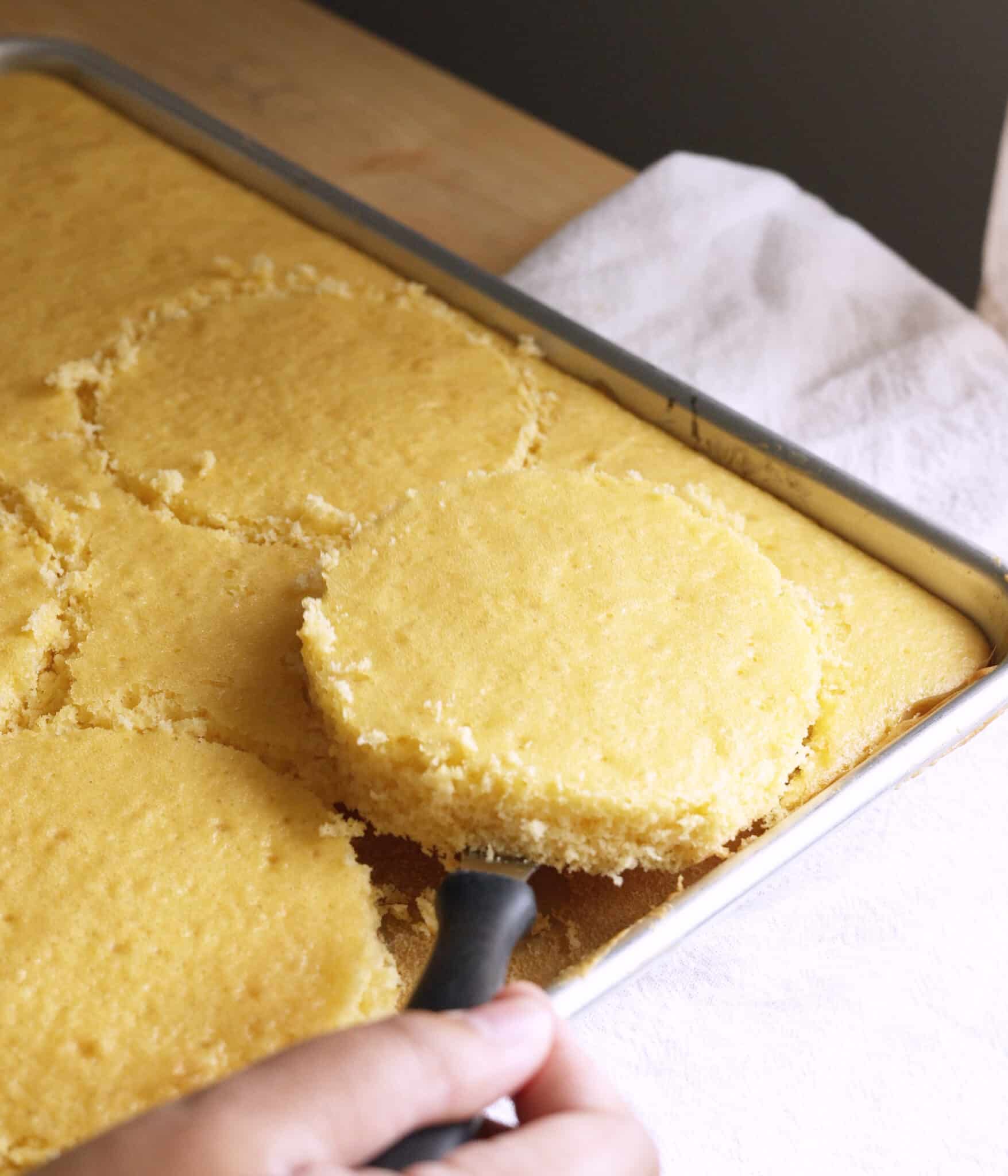 Using an offset spatula to lift cake layer from pan.