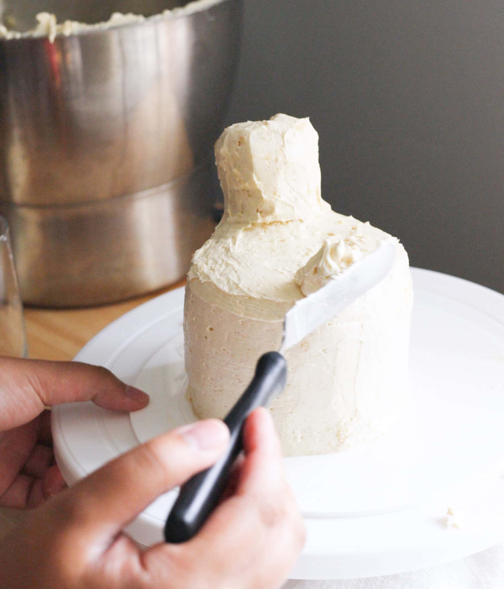Crumb coating chicken cake with Swiss meringue buttercream.