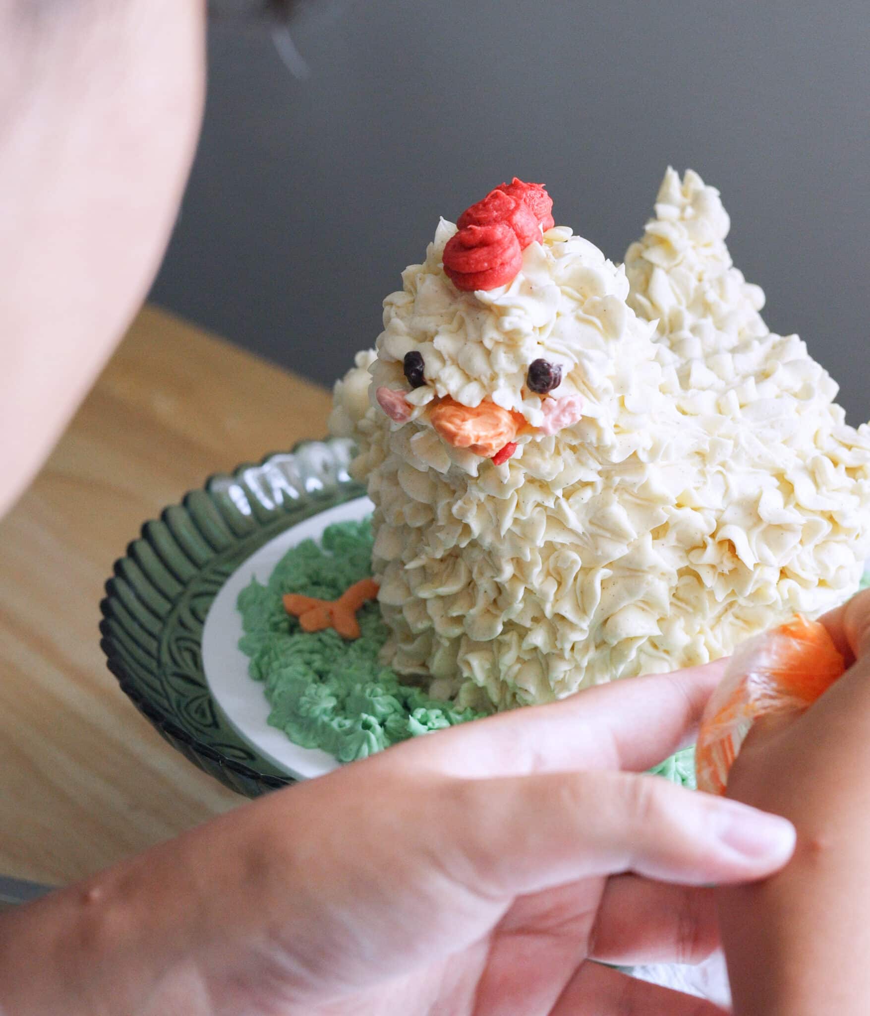 Decorating chicken cake with homemade Swiss meringue buttercream.