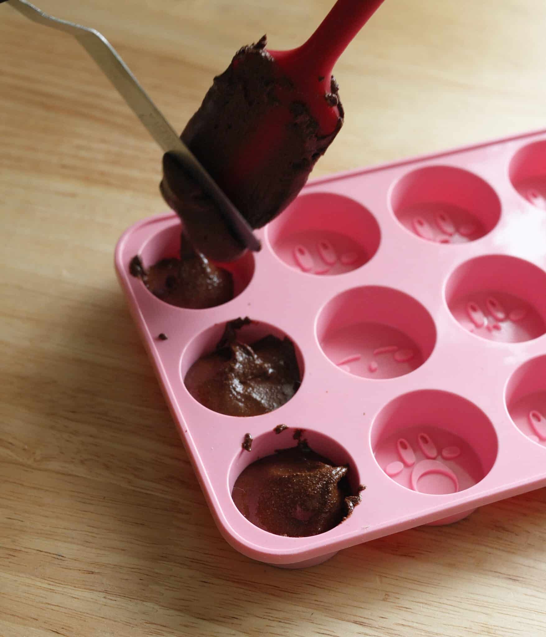 Transferring homemade chocolate to mold.