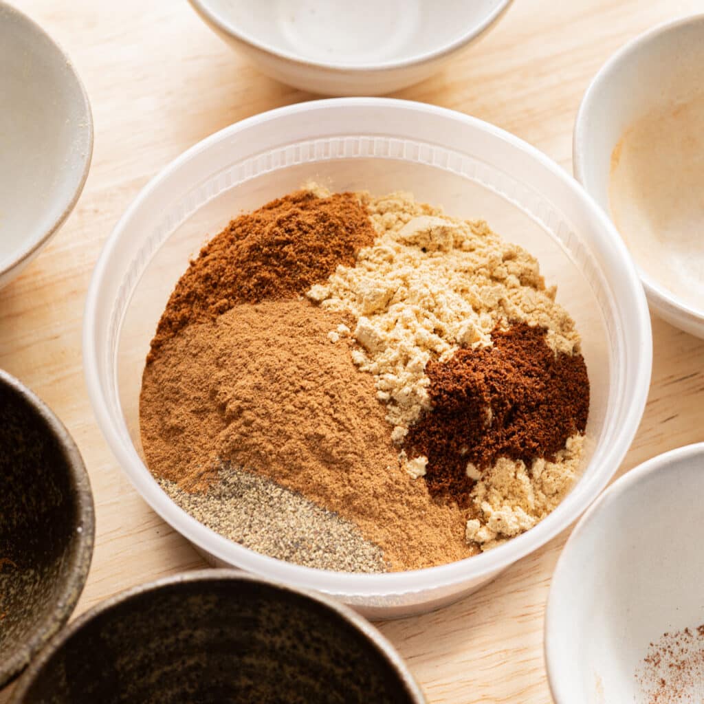 Chai spice mix ingredients in a plastic container.