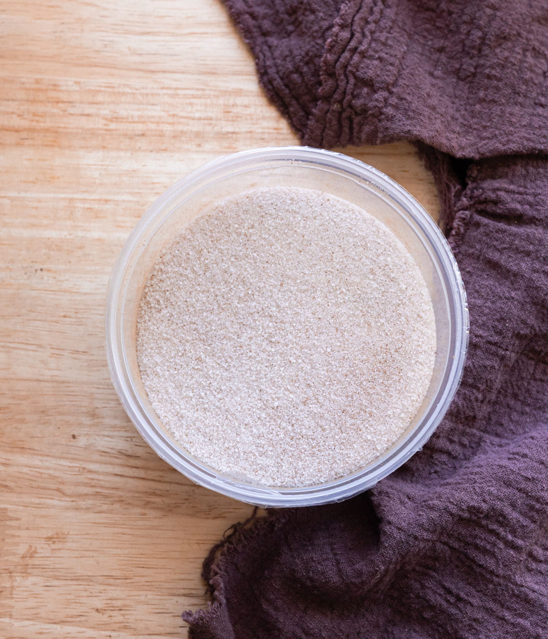 Homemade chai sugar in a plastic container.