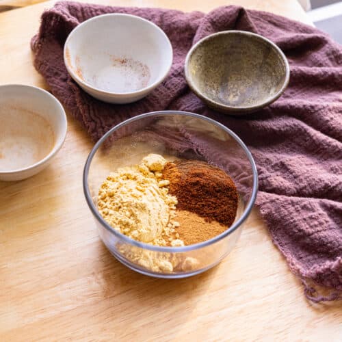 Gingerbread spice mix ingredients in a glass container.