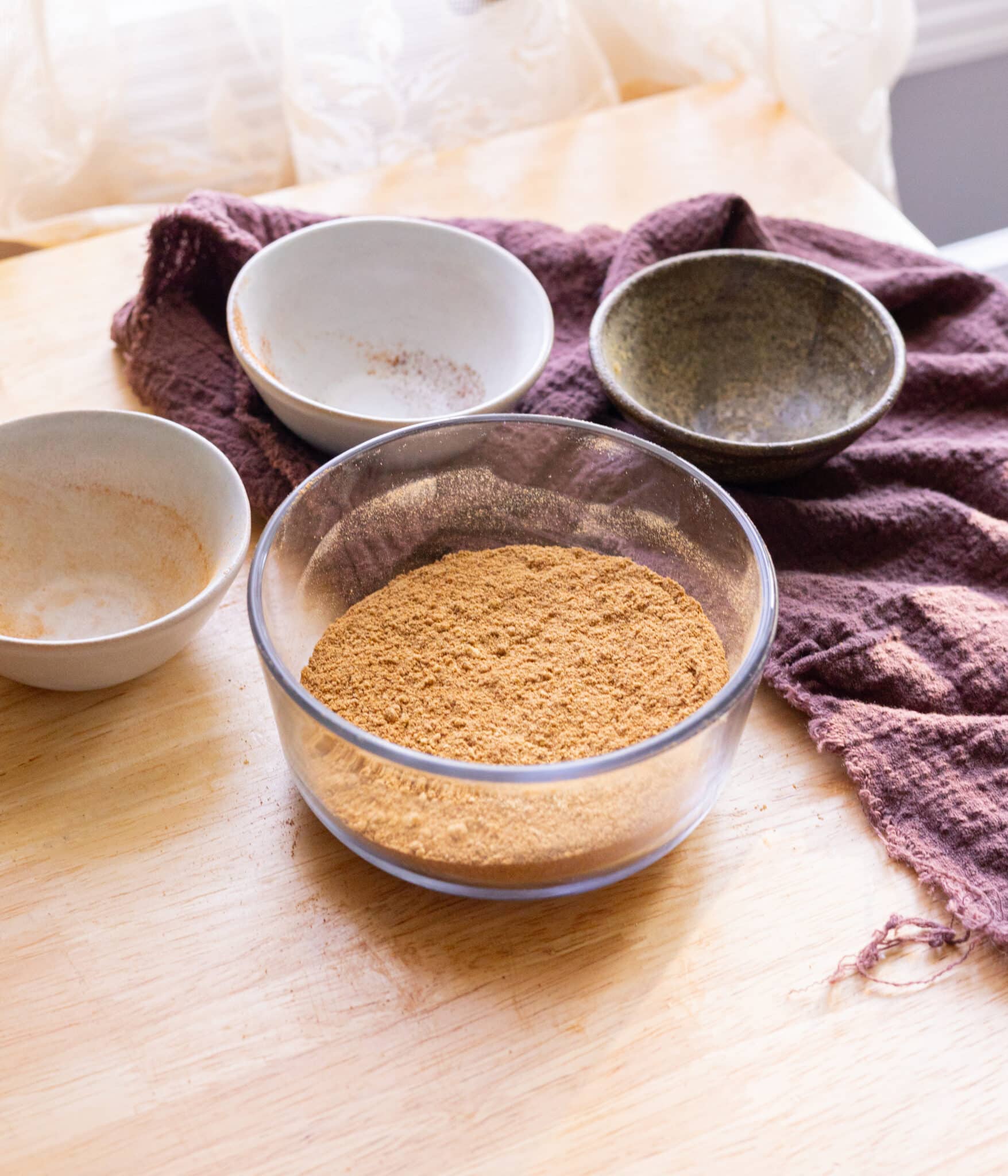 Gingerbread spice mix ingredients mixed together in a glass container.