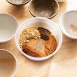 Pumpkin pie spice mix ingredients in a plastic container.