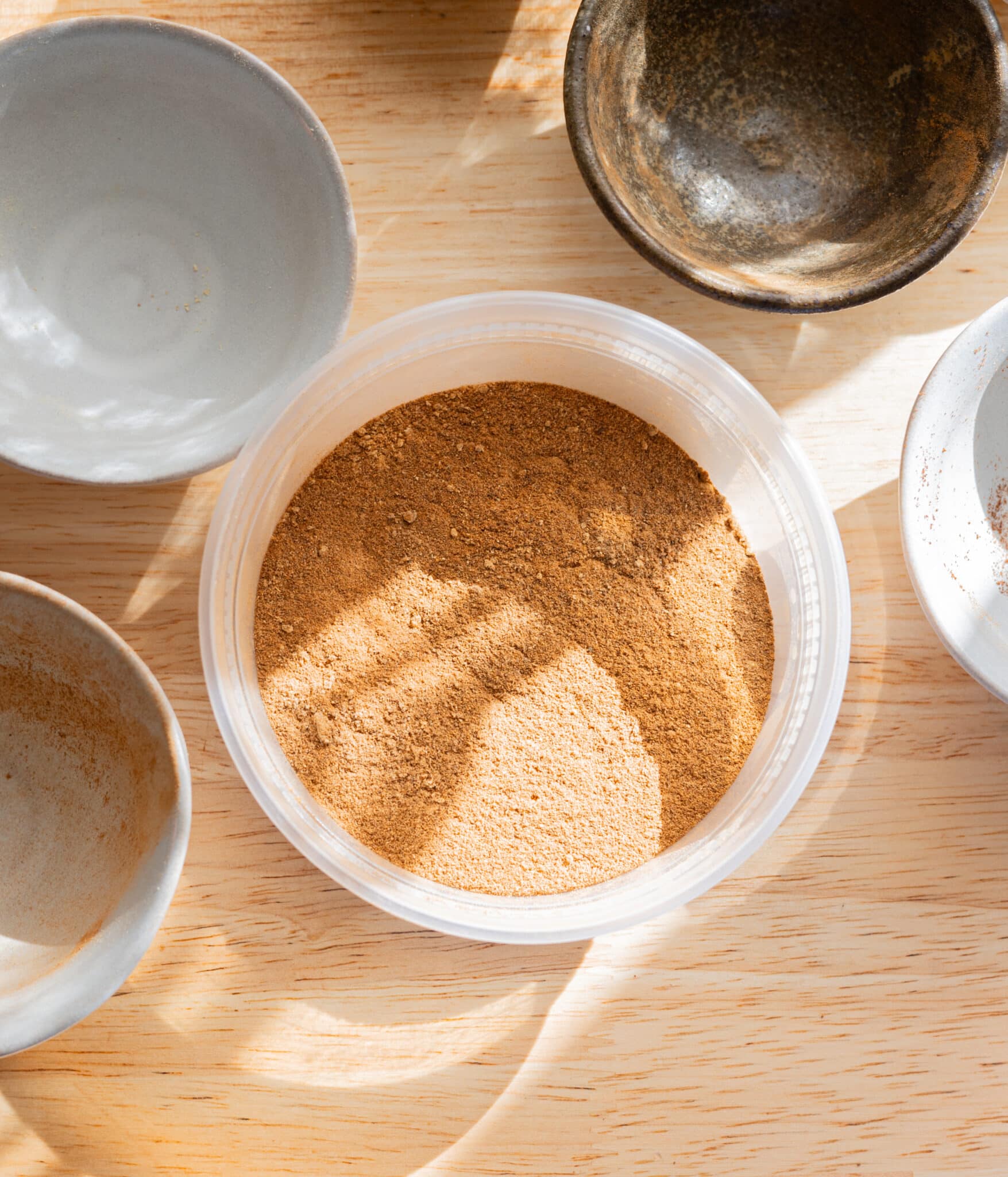 Mixed pumpkin pie spice in a plastic container.