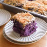 Ube coconut roll on a fluted plate.