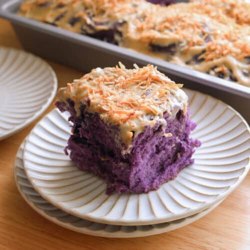 Ube coconut roll on a fluted plate.