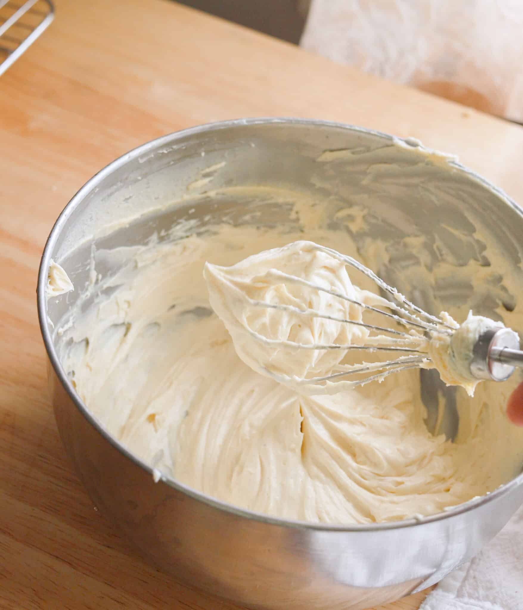 Whipped banana pudding cream cheese frosting in a stainless steel bowl.