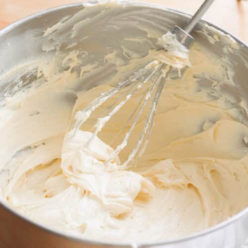 Whipped banana pudding cream cheese frosting in a stainless steel bowl.