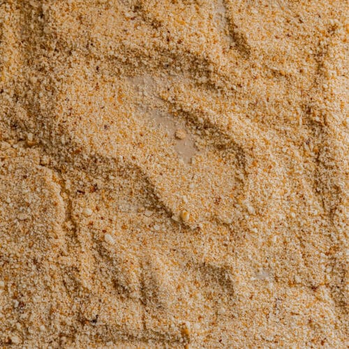 Toasted breadcrumbs spread out on a sheet pan.