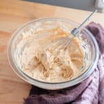 Chai frosting in a glass mixing bowl.