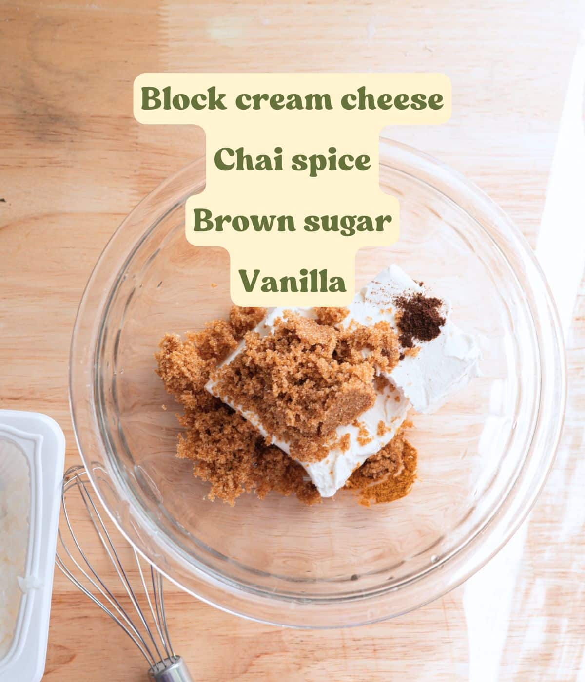 Labeled chai spice cinnamon roll frosting ingredients laid out on a table.