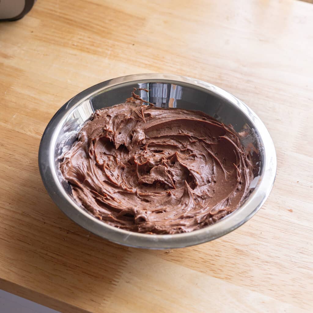 Milo cream cheese frosting in a stainless steel bowl.