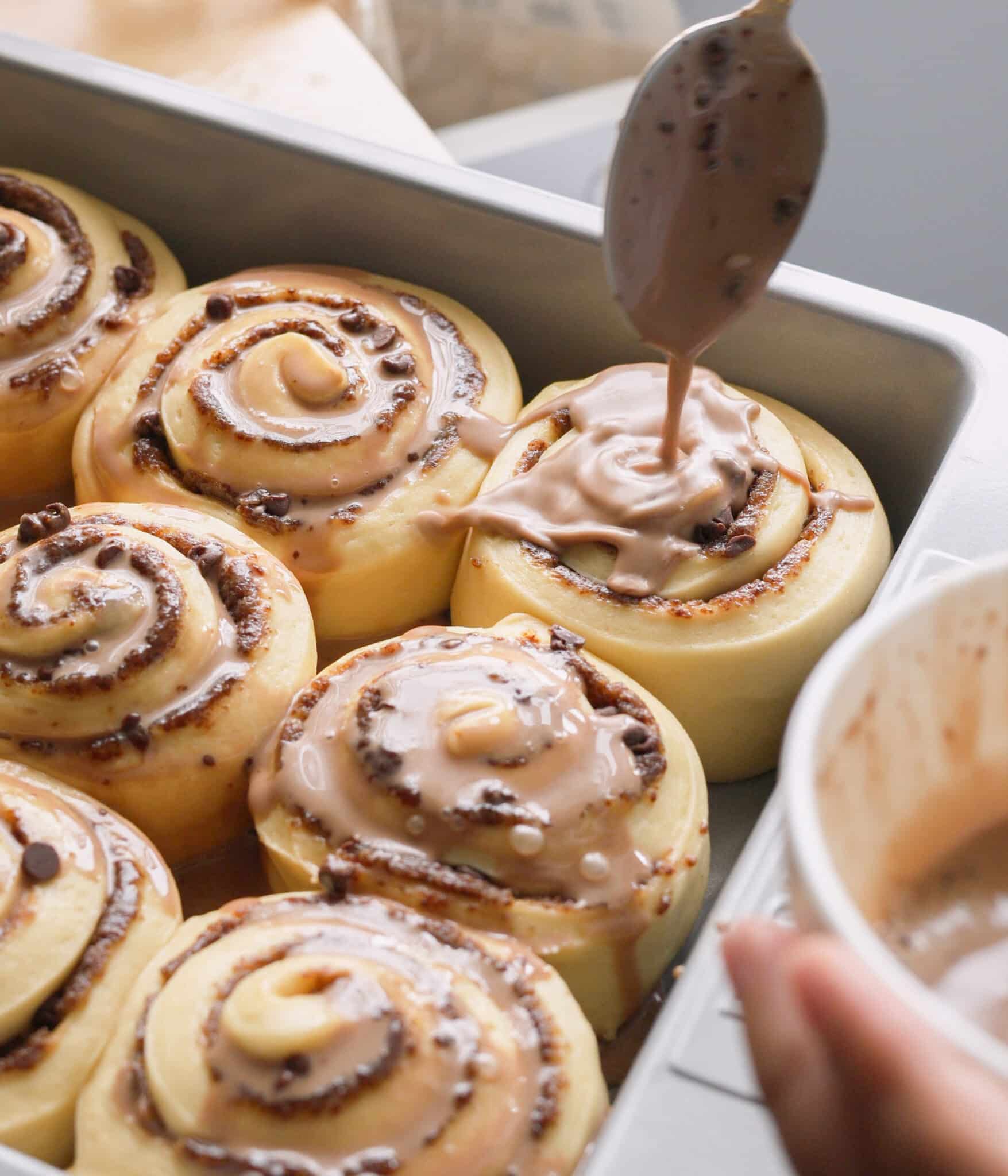 Pouring Milo heavy cream on top of rolls.