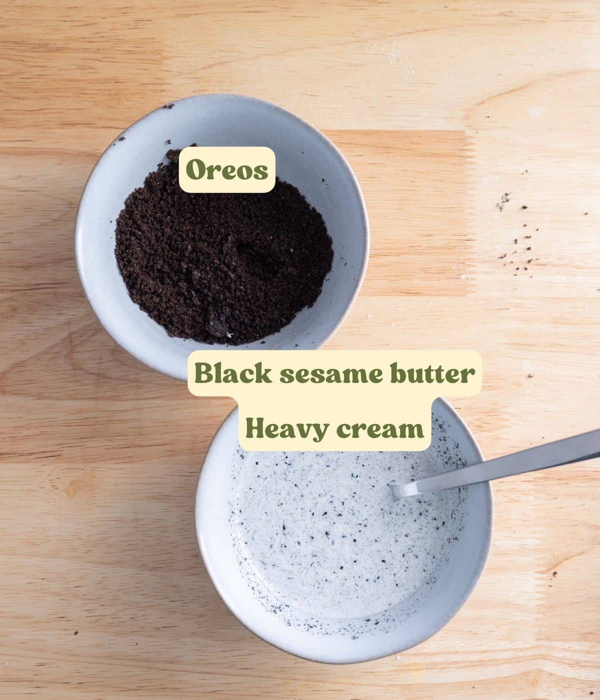 Black sesame heavy cream and topping ingredients labeled on a wooden table.