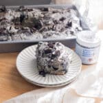 Oreo black sesame roll on a white fluted plate.