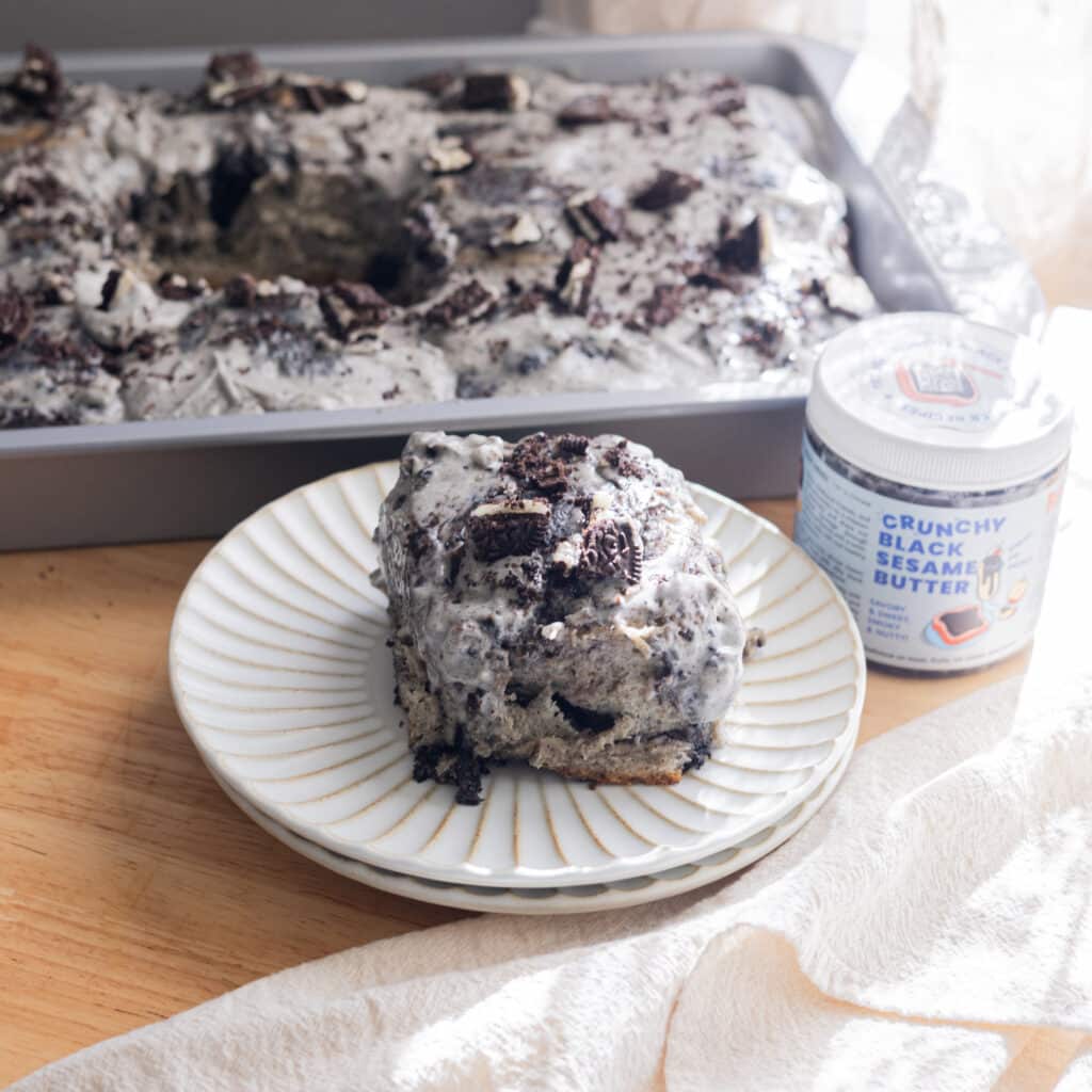 Oreo black sesame roll on a white fluted plate.