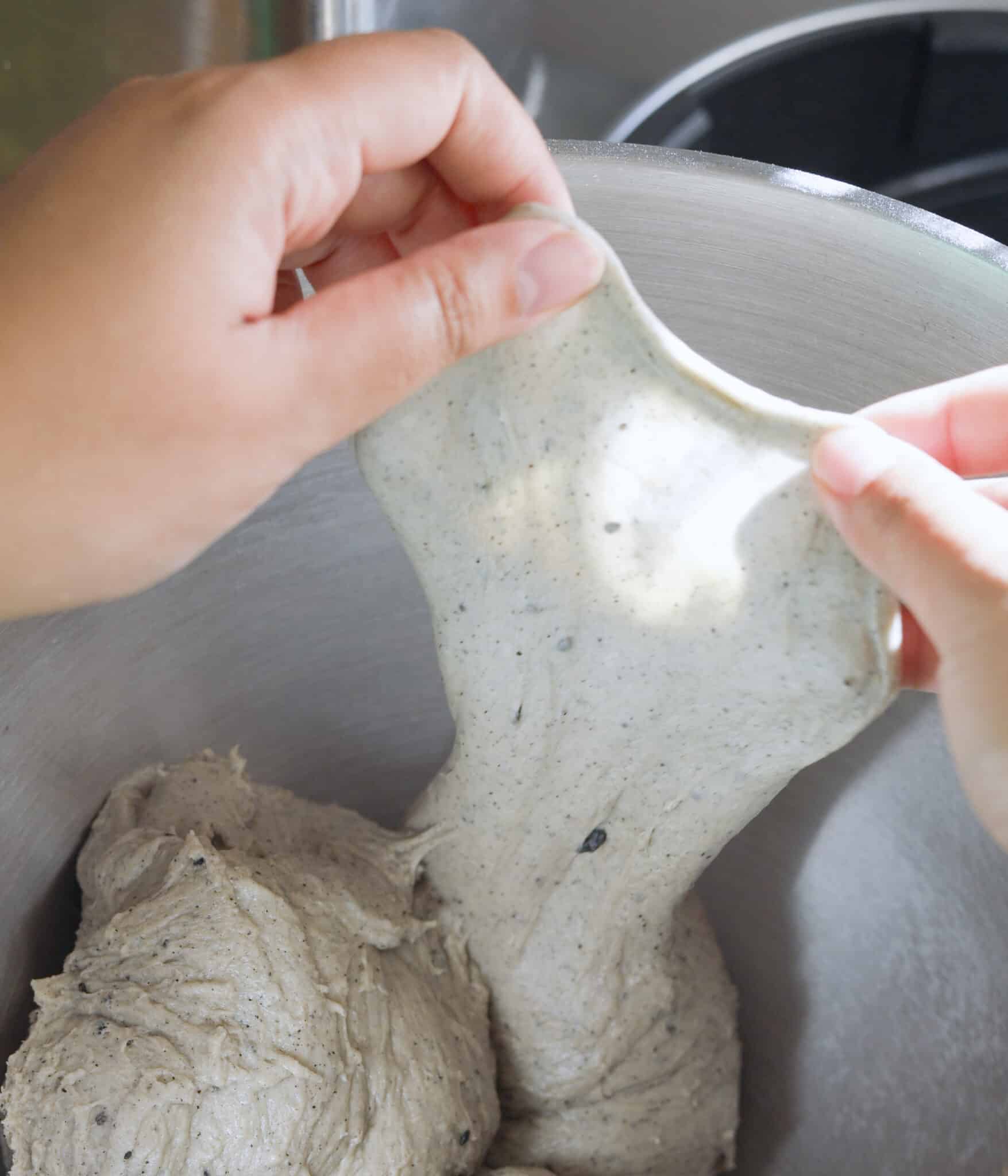 Black sesame brioche roll dough passing the windowpane test.