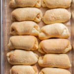 Spanish bread on a lined baking sheet.