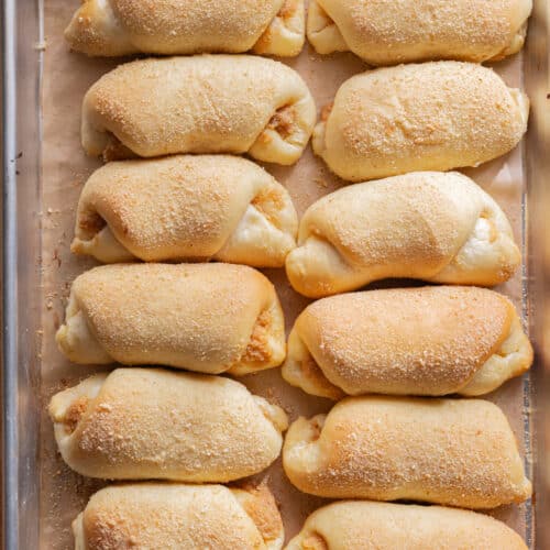 Spanish bread on a lined baking sheet.