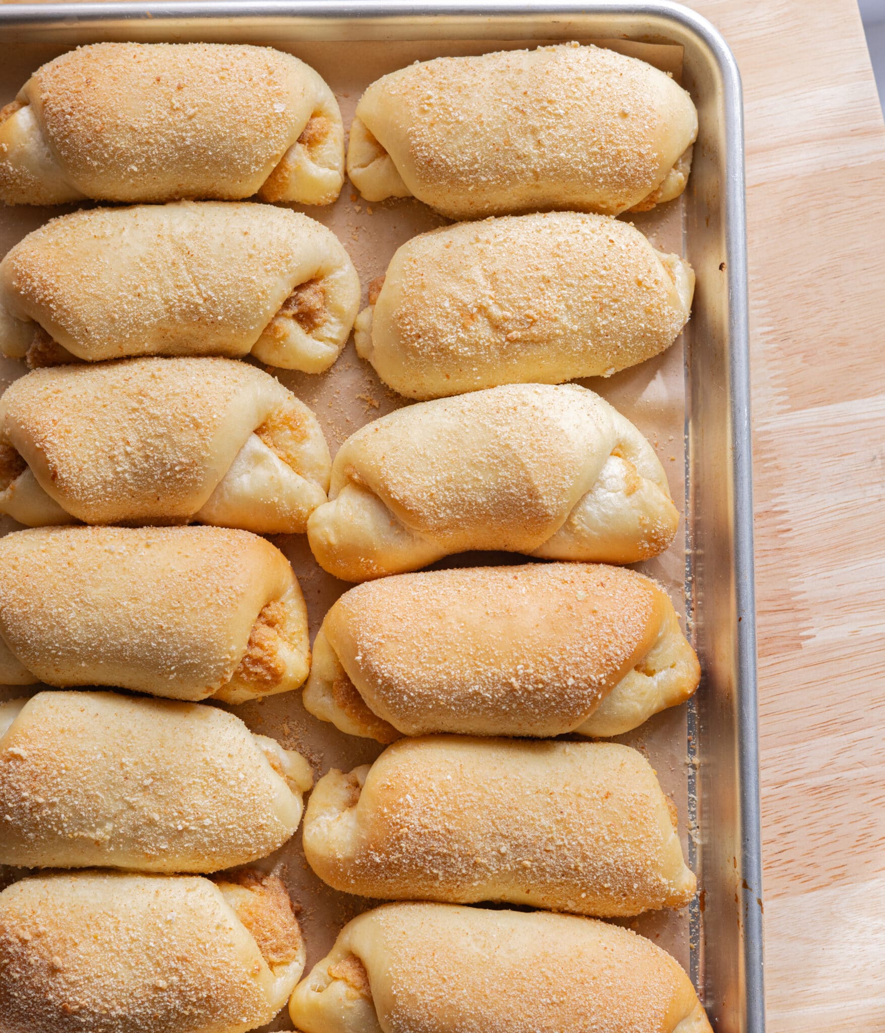 Spanish bread on a lined baking sheet.