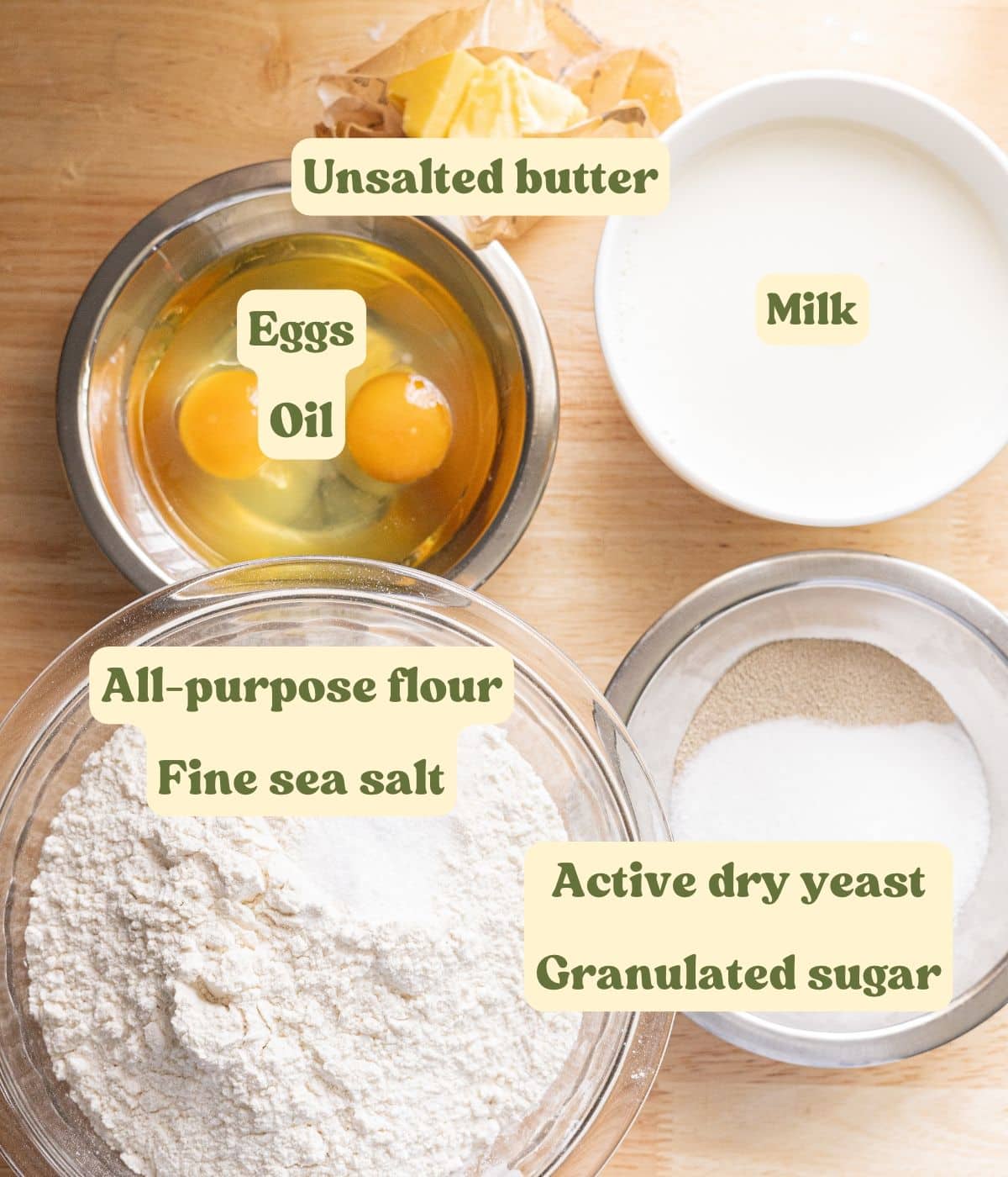 Labeled Spanish bread dough ingredients laid out on a table.